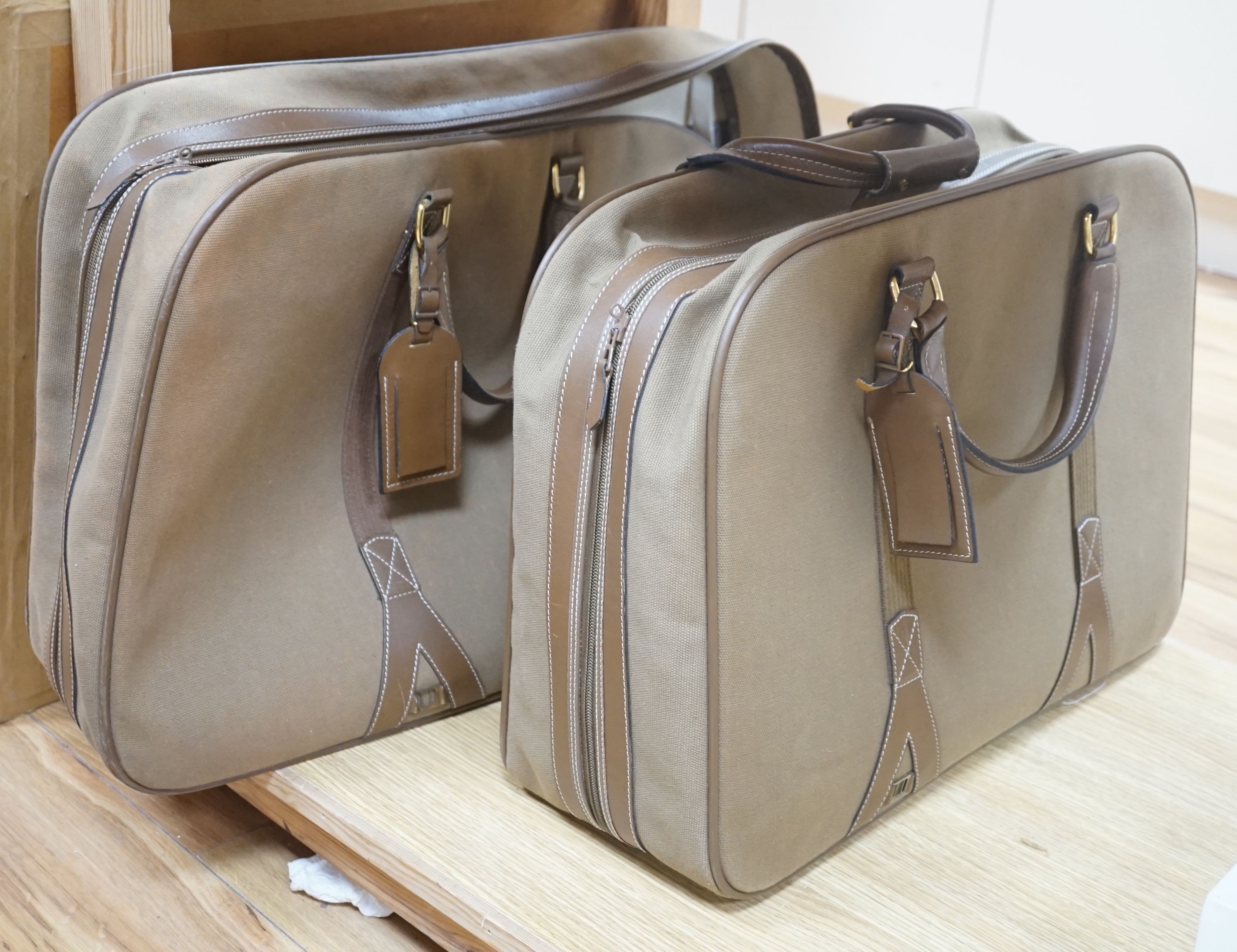Two 1980's soft canvas Dunhill suit cases, largest 65 cms wide x 42 ms high.